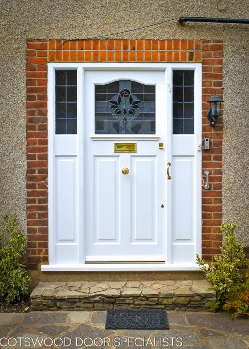 1920s Front entrance door with curved stained glass. Door fitted with brass locks and furniture. Fully spray painted satin white. Double sidelight door frame.