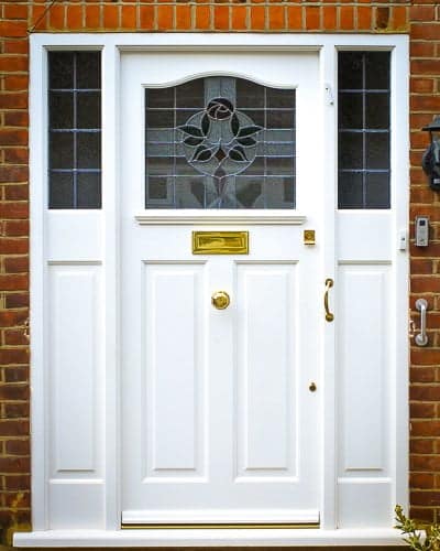1920s Front entrance door with curved stained glass. Door fitted with brass locks and furniture