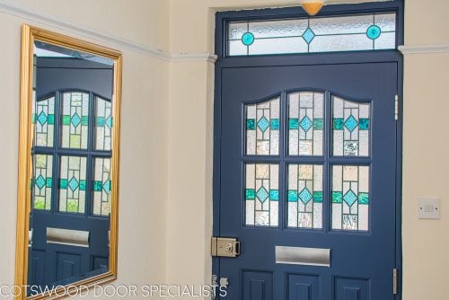 1930's Grey spray painted six light front door. Door with stained and leaded glass as double glazed unit. View from hallway with light shining though stained glass
