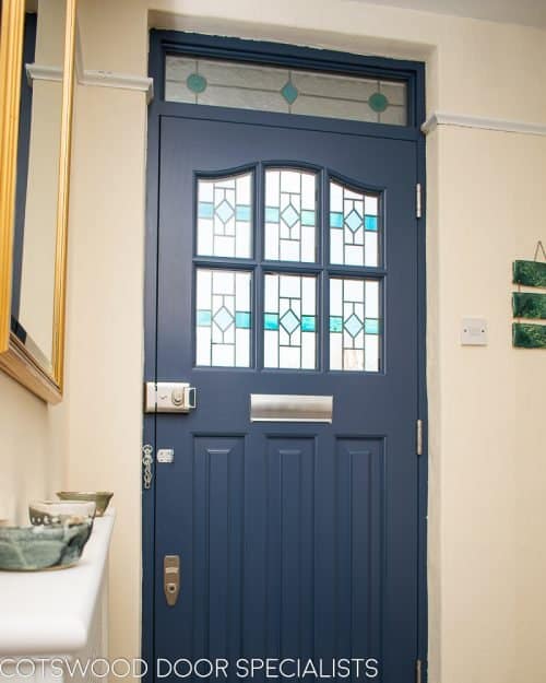 1930's Grey spray painted six light front door. Door with stained and leaded glass as double glazed unit. View from hallway with light shining though stained glass