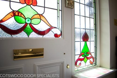 Edwardian front entrance door with stained glass. Decorative shaped glass in door antique door furniture. New door frame. Door and frame spray painted. View from hallway