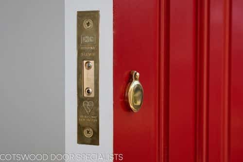 Late Edwardian red front door and sidelight frame. Shot from hallway of door locks and security