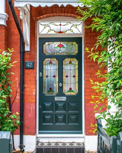 Ornate Edwardian front door stained glass. Door painted dark green