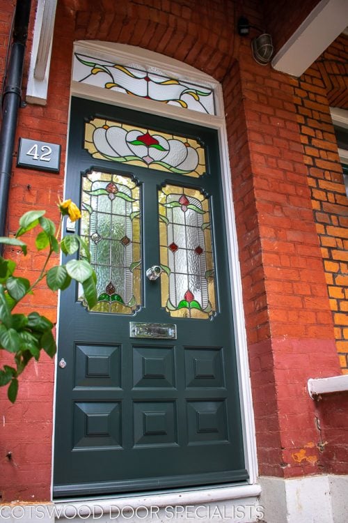 Ornate Edwardian front door stained glass. Door painted dark green