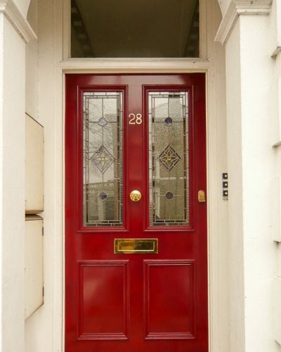 Red Victorian front door with leaded glass