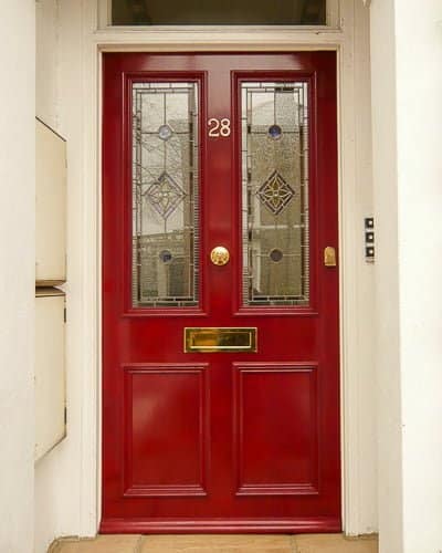 Red Victorian front door with leaded glass