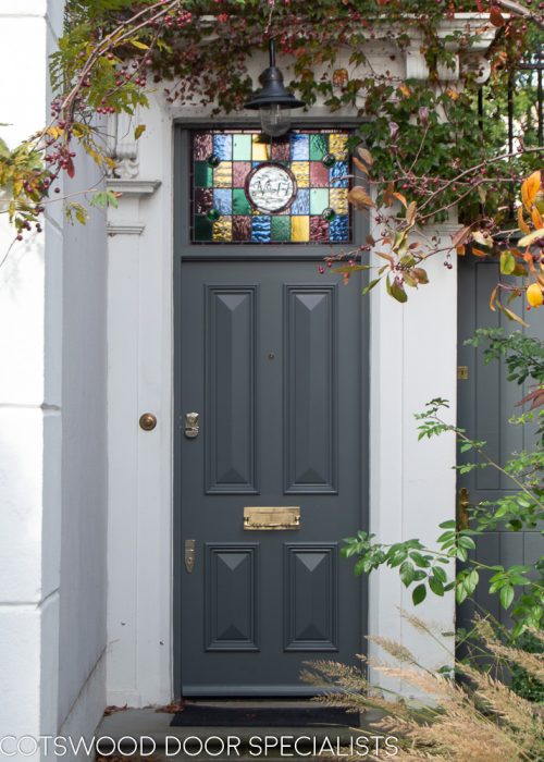 Dark grey Victorian front door solid with no glass. Stained glass to door frame