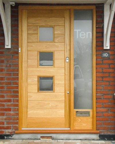 Contemporary glazed front door and sidelight frame. Etched glass in frame with number. Light stained natural wood