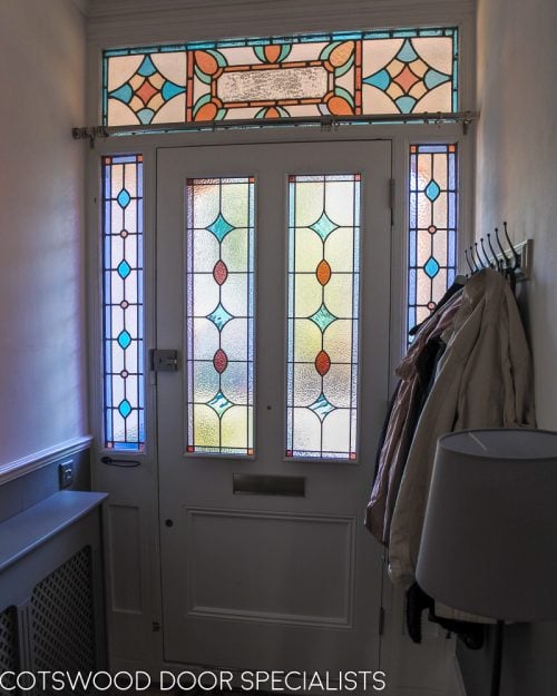 Late Victorian front door painted white internally. Light shining though the leaded glass