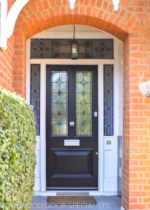 Late Victorian style dark blue painted front door. Door and frame with stained glass. Satin chrome door furniture