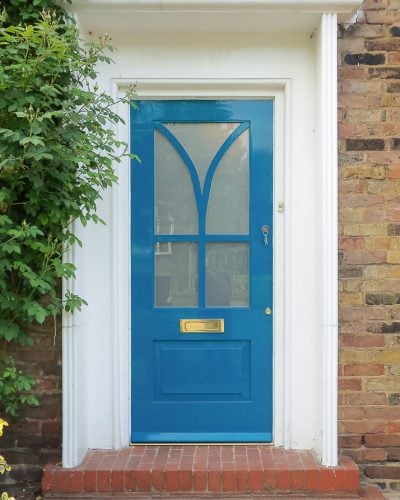 Modern painted wooden front door. Satin etched glass. Interesting wooden glazing bar. Unique modern front door design. Blue paint