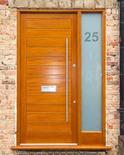 Modern wooden door and sidelight frame. Solid door with horizontal boards. Etched glass in sidelight with clear number. Satin chrome door furniture with long bar handle.