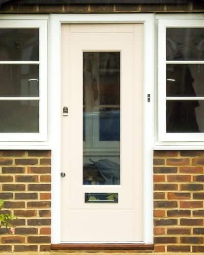 Spray painted contemporary front door with clear glass. Double glazed. Door with polished chrome door furniture