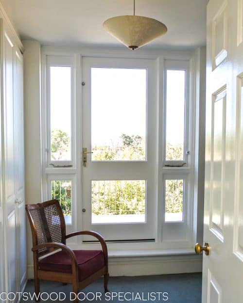 Balcony french door made in Accoya wood and painted white. Clear double glazed glass and satin chrome door fittings. Fitted into a London balcony, viewed from inside of house looking out
