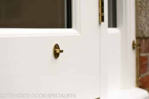 Brass cabin hook on wooden french doors