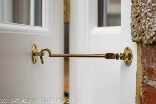 Brass cabin hook on wooden french doors