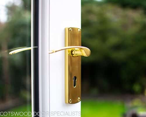 Brass door handle on wooden french doors