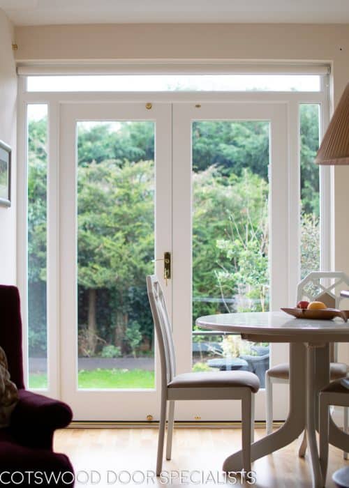 White painted wooden glazed french door with sidelight frame. Double glazed clear glass and brass hardware