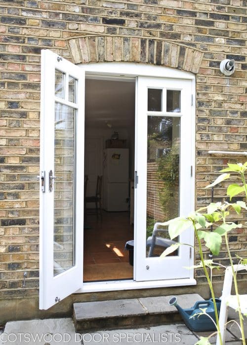 Victorian back door pair and new frame. Fitted into a Victorian terraced house with London stock brickwork. Doors fully double glazed incorporating a decorative wooden glazing bar. Polished Chrome door furniture and insurance approved deadlock.