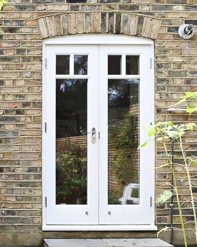 Victorian back door pair and new frame. Fitted into a Victorian terraced house with London stock brickwork. Doors fully double glazed incorporating a decorative wooden glazing bar. Polished Chrome door furniture and insurance approved deadlock.