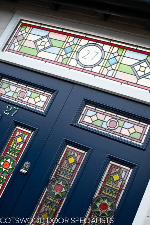 Victorian double doors with stained and leaded glass. Doors are painted dark blue with Teknos spray paint, finish is beautiful. Intricate stained glass design to the doors and the frame. The new door frame has the number above the doors incorporated in the stained glass.