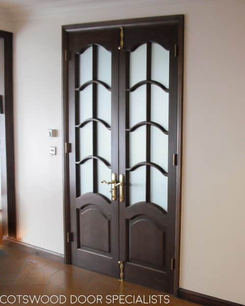 Tall glazed internal doors, arched glass with glazing bars, dark wood stain, arched obscure glass, polished brass furniture
