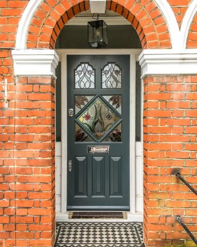 Edwardian front door painted slate grey with diamond stained glass and polished chrome furniture fitted into existing frame in London