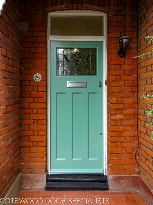 1920's Era front door with stained glass fitted into an existing door frame. Door has traditional features including stained glass. Simple mouldings to door. Painted light green in colour with satin chrome furniture.
