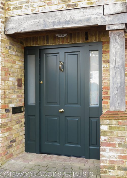 Raised panelled solid Victorian front door and new frame. Bespoke traditional door fitted into an open porch surrounded by oak beams. New door is painted dark green and the frame is also dark green. High security multi point locking system. Antique brass door furniture fitted with a Doctor knocker and a door knob