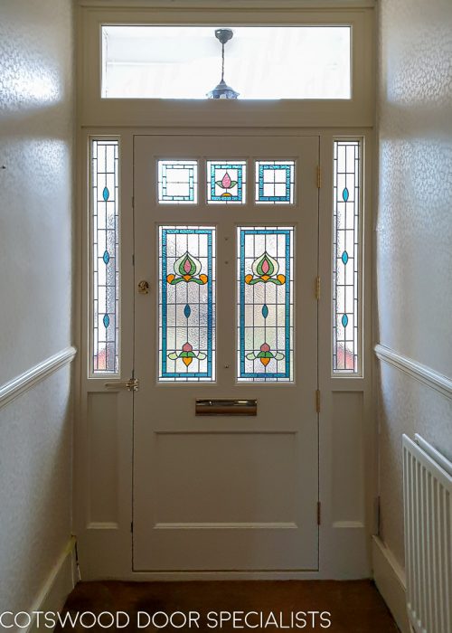 Victorian external door fitted with a new decorative door frame. Traditional stained glass made as double glazed units. Painted door and frame. Door furniture. Wide Victorian open porch with Victorian style tiles