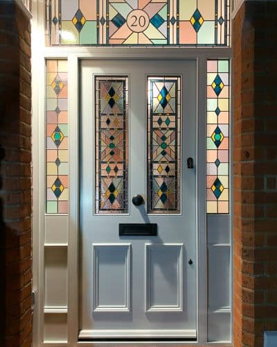 Victorian front entrance with leaded lights. Beautiful geometric stained glass design with number above door. All fully painted light grey. Door furniture is smooth black finish.