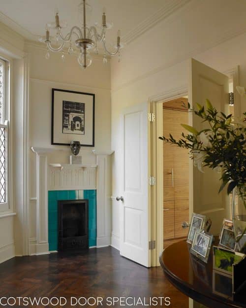 Painted raised panel internal doors fitted in an Edwardian hallway. Hallway has art nouveaux fireplace