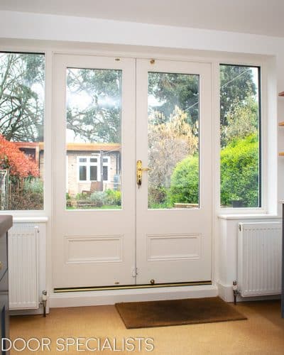 Victorian glazed french doors. French doors with clear double glazed glass. Sidelights have triple glazing with just over half glass. All painted in satin off white