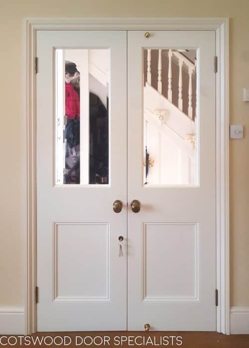 White Victorian style internal doors with clear bevelled glass. Victorian brass door knobs and white painted doors.Flat panels with inset panel moulding