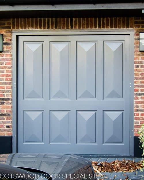 Victorian style garage door. Door is an up and over electrically operated garage door. Cricket bat wooden panels