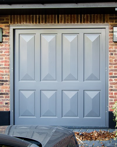 Victorian style garage door. Door is an up and over electrically operated garage door. Cricket bat wooden panels