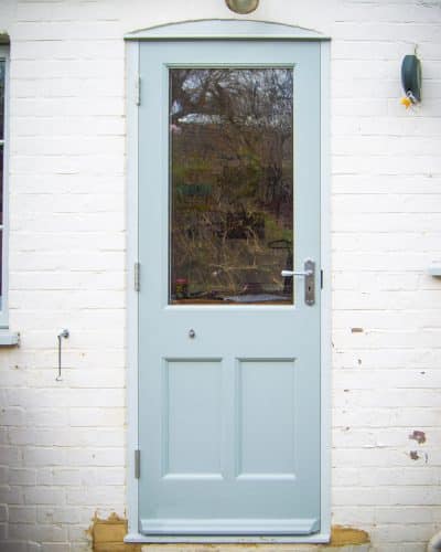 Wooden back door painted light blue. Fitted with clear glass and a cabin hook to hold door back against wall. Furniture is satin chrome.