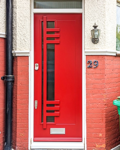 Bespoke contemporary front door in pillar box red. A Modernist design with reeded glass panels.