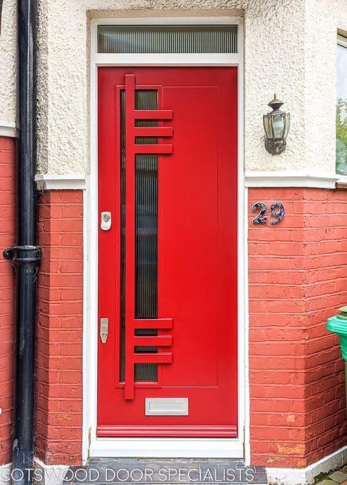 Bespoke contemporary front door in pillar box red. A Modernist door design with reeded glass panels.