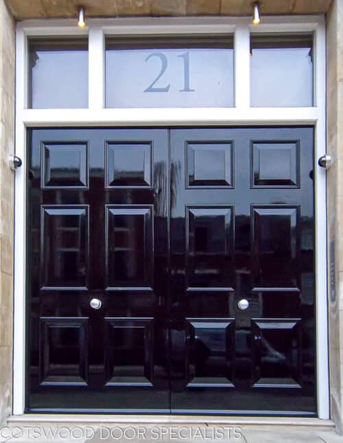 Black Georgian double doors. Large black georgian 6 panel double doors fitted into an impressive london property. White frame with etched glass fanlight and number. Stone portico surrounding doors