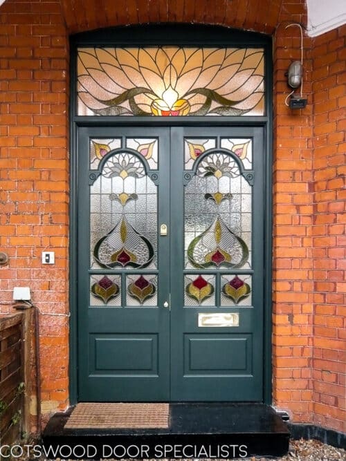 Decorative Edwardian double doors fitted into a large red bricked Edwardian London home. Beautiful stained glass design to doors with decorative fanlight. doors painted a rich green colour