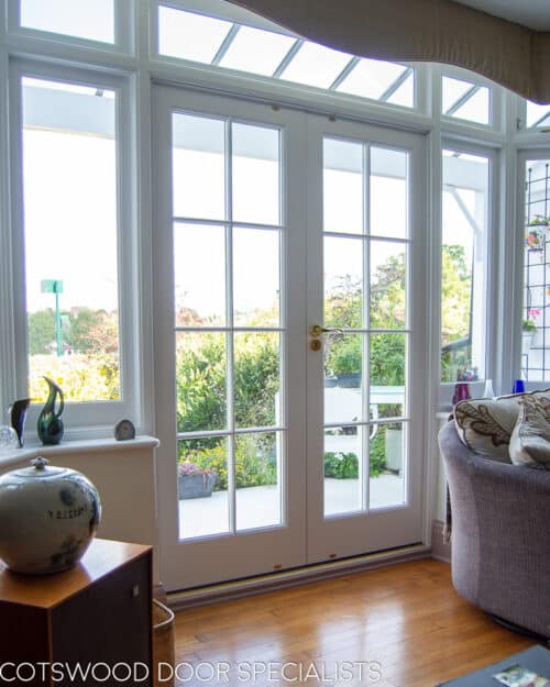 1920s Bay window and door. Large white painted wooden bay window and french door. All double glazed with clear glass. Bay lets lots of light though from suntrap patio. Doors have wooden glazing bar dividing the glass into multiple panes