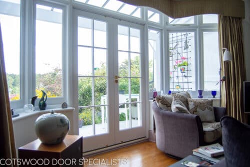 1920s Bay window and door. Large white painted wooden bay window and french door. All double glazed with clear glass. Bay lets lots of light though from suntrap patio. Doors have wooden glazing bar dividing the glass into multiple panes