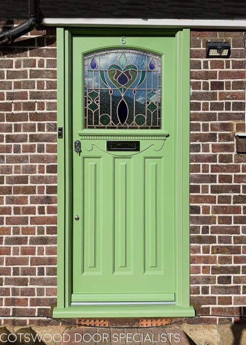 Art Nouveau style 1920s door. Art nouveau stained glass fitted into a 1930s front door. Door has some Edwardian features like a very decorative shelf with dental block and scrolled apron