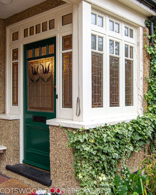 Edwardian casement window. Large Edwardian casement window incorporated into a front entrance doorway. Decorative wooden glazing bars dividing window into multiple panes. Stained glass to window. All double glazed. White painted wooden window