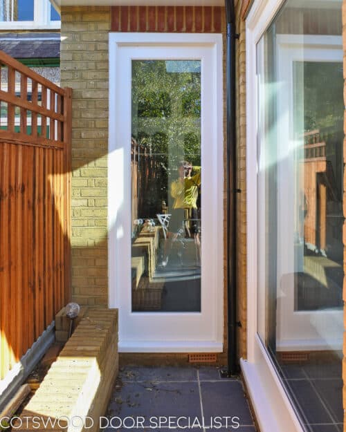 Fixed casement window. Tall white wooden accoya casement window. Series of windows fitted into kitchen full height of doors. Double glazed with clear glass