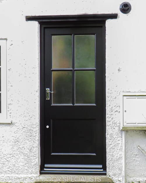 Four glass back door. Classic back door with glazing bar dividing the glass into four panes. Flat panel in the bottom of the door with a catflap