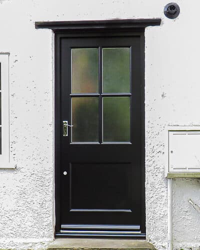 Four glass back door. Classic back door with glazing bar dividing the glass into four panes. Flat panel in the bottom of the door with a catflat