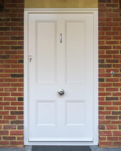 White Victorian front door. Extra wide white Victorian 4 panelled front door. Elegant brassart door furniture in polished chrome. door has recessed panels with panel moulding. High security multipoint lock is fitted to door. Door is fitted in large timber framed open porch