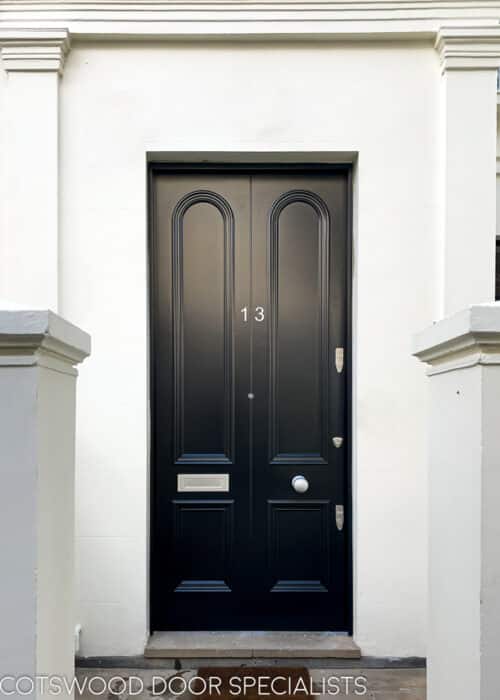 Curved moulding Victorian door. Transitional front door between Georgian and Victorian period. Extra tall and wide door, made to look like a pair with a beading to centre. All painted satin black with satin chrome hardware. Copy of original door and mouldings.